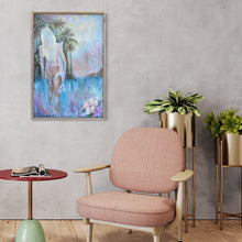 Load image into Gallery viewer, Girl in a bikini holding a surfboard standing in front of aqua blue water and palm trees. In situ on a sitting room wall.