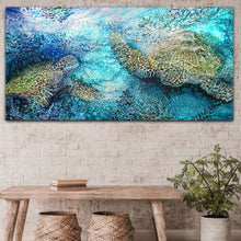 Load image into Gallery viewer, Painting of green sea turtles swimming. Painting shown in situ on a beige brick wall.