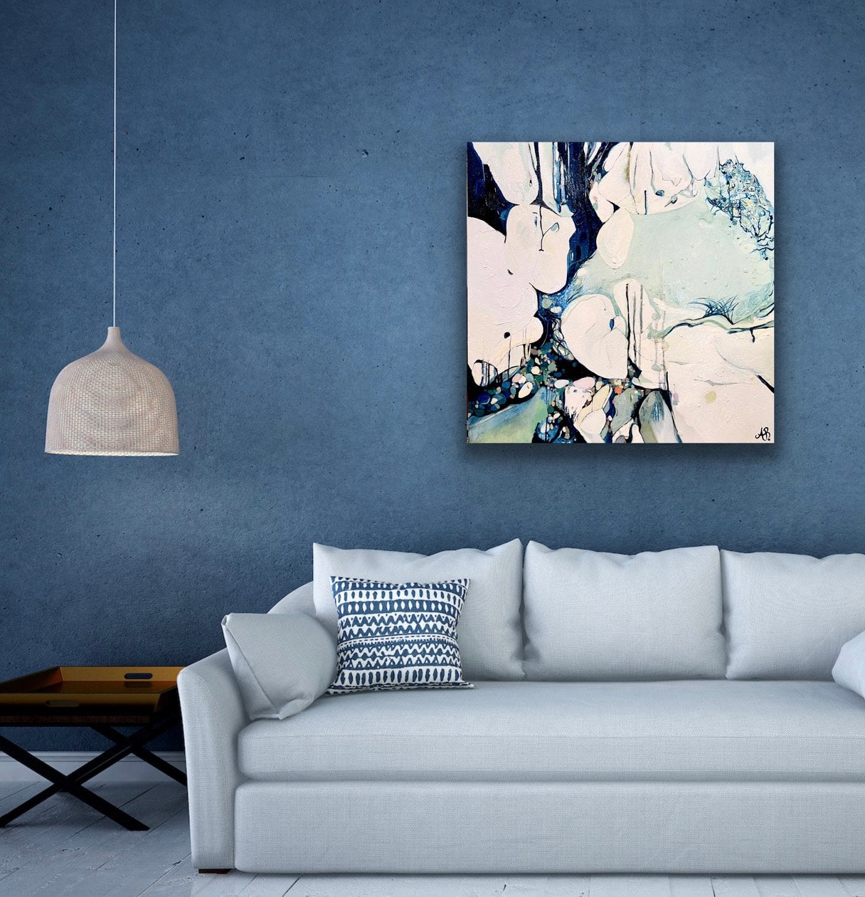 Abstract oil painting based on ocean rock pools in shades of cream, navy, aqua, pale green and a small splash of ochre. Shown in situ on a mid blue living room wall.