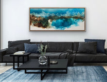 Load image into Gallery viewer, Ocean and beach in bright shade of aqua and white, with rocks at the end of a cove, painted in an abstract style. In situ on a living room wall.
