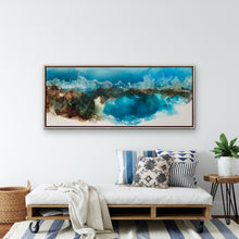 Load image into Gallery viewer, Ocean and beach in bright shade of aqua and white, with rocks at the end of a cove, painted in an abstract style. In situ on a white wall.

