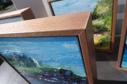 Abstract view of Kiama lighthouse in front of Norfolk Island Pines on a headland with a sapphire ocean.