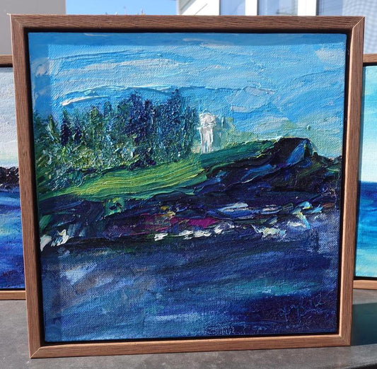 Abstract view of Kiama lighthouse in front of Norfolk Island Pines on a headland with a sapphire ocean. Framed view.
