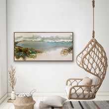Load image into Gallery viewer, Ocean and beach scene with puffy clouds on the horizon and rocks in jewel like colours, painted in an abstract style. In situ on a white wall.
