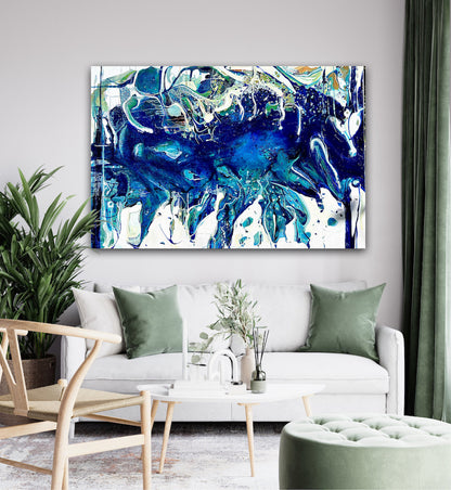 Abstract oil painting on a white background in shades of blue, white and green, shown on wall in living room.