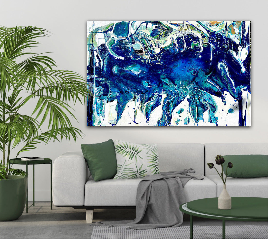 Abstract oil painting on a white background in shades of blue, white and green, on grey wall next to a palm.