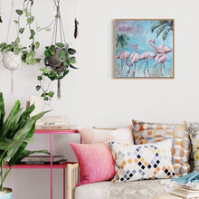 Load image into Gallery viewer, Five flamingos against an aqua blue background and two palm trees. On a white wall.
