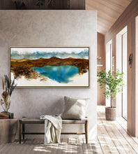 Load image into Gallery viewer, Row of hills around an aqua blue lake and blue and white clouds, painted in abstract style. In situ on a dividing wall.
