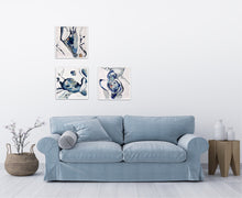 Load image into Gallery viewer, Oil painting of a rock pool in an abstract style on a white background in shades of blue with multicoloured detail. In situ on a white wall with 2 other matching paintings.
