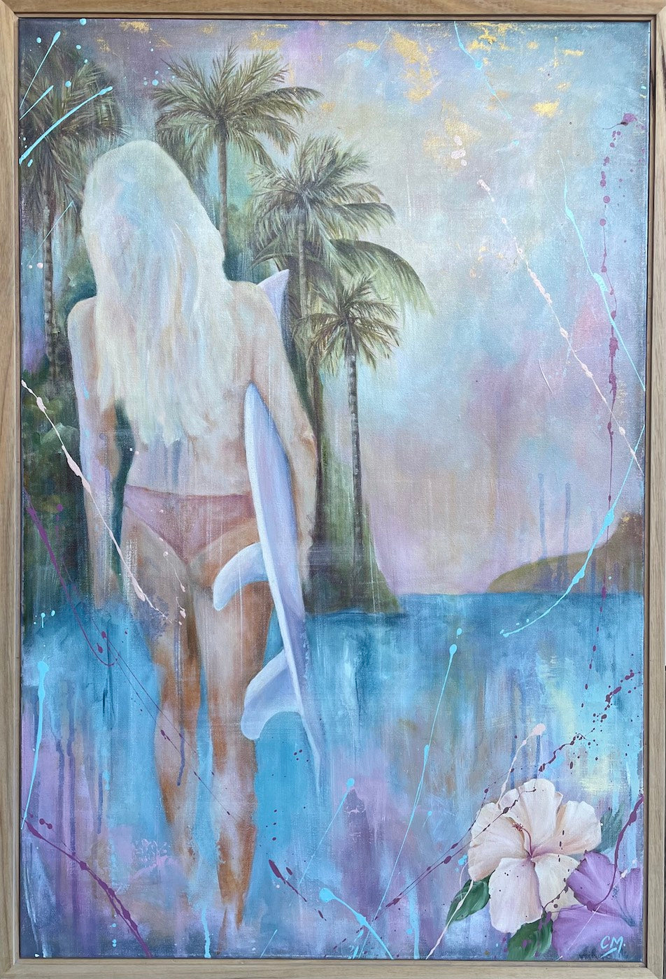 Girl in a bikini holding a surfboard standing in front of aqua blue water and palm trees. Framed in raw Tasmanian oak.