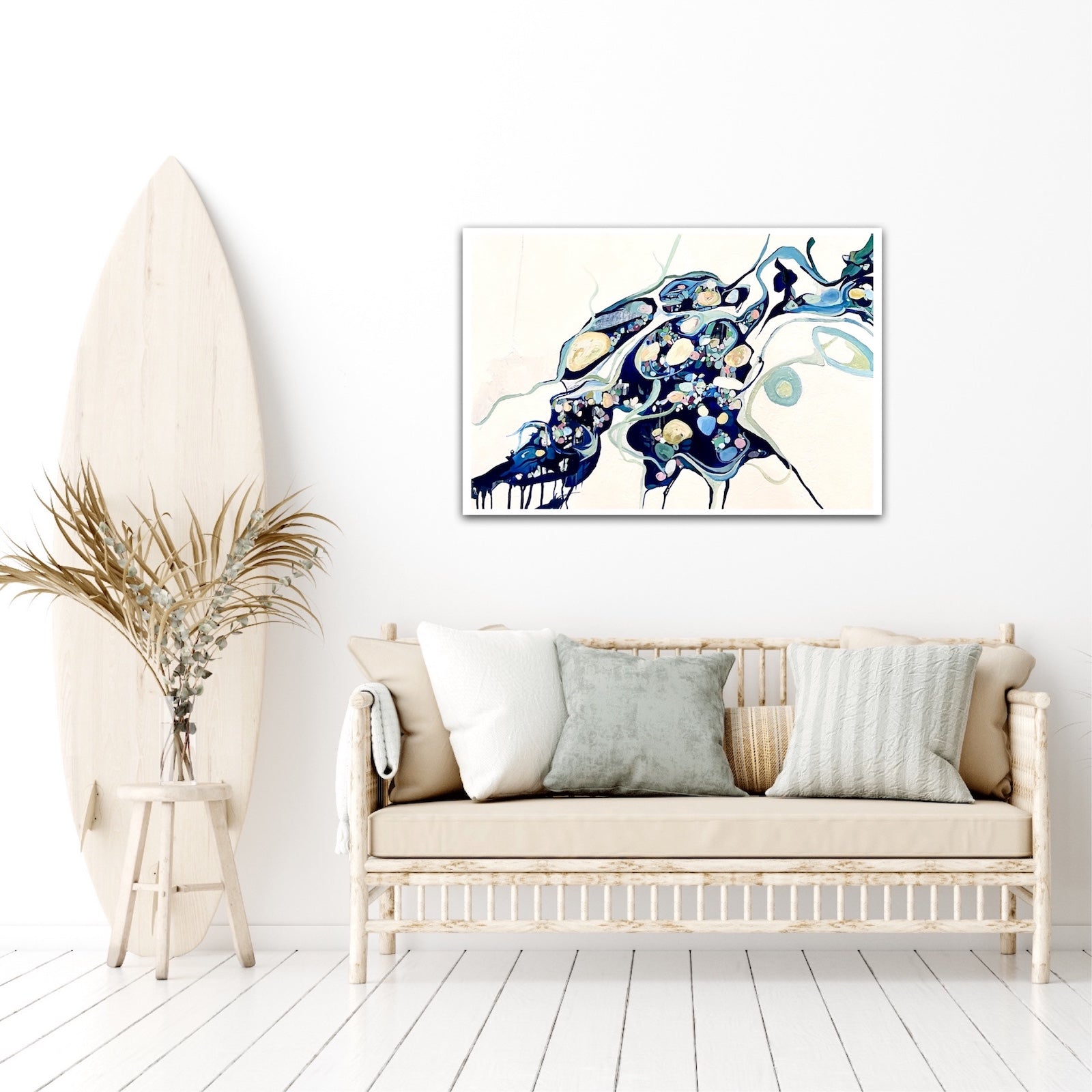 Abstract oil painting on a white background in shades of blue, cream and green with multicoloured details on sitting room wall.
