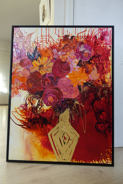 Gold vase with a mass of pink, red and orange blooms with red, gold and white background