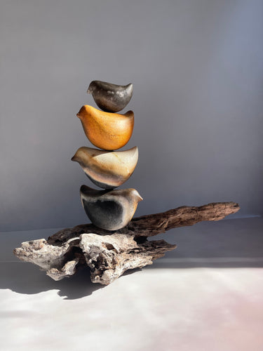 Ceramic Totem sculpture with 4 ceramic birds sitting on a piece of driftwood.