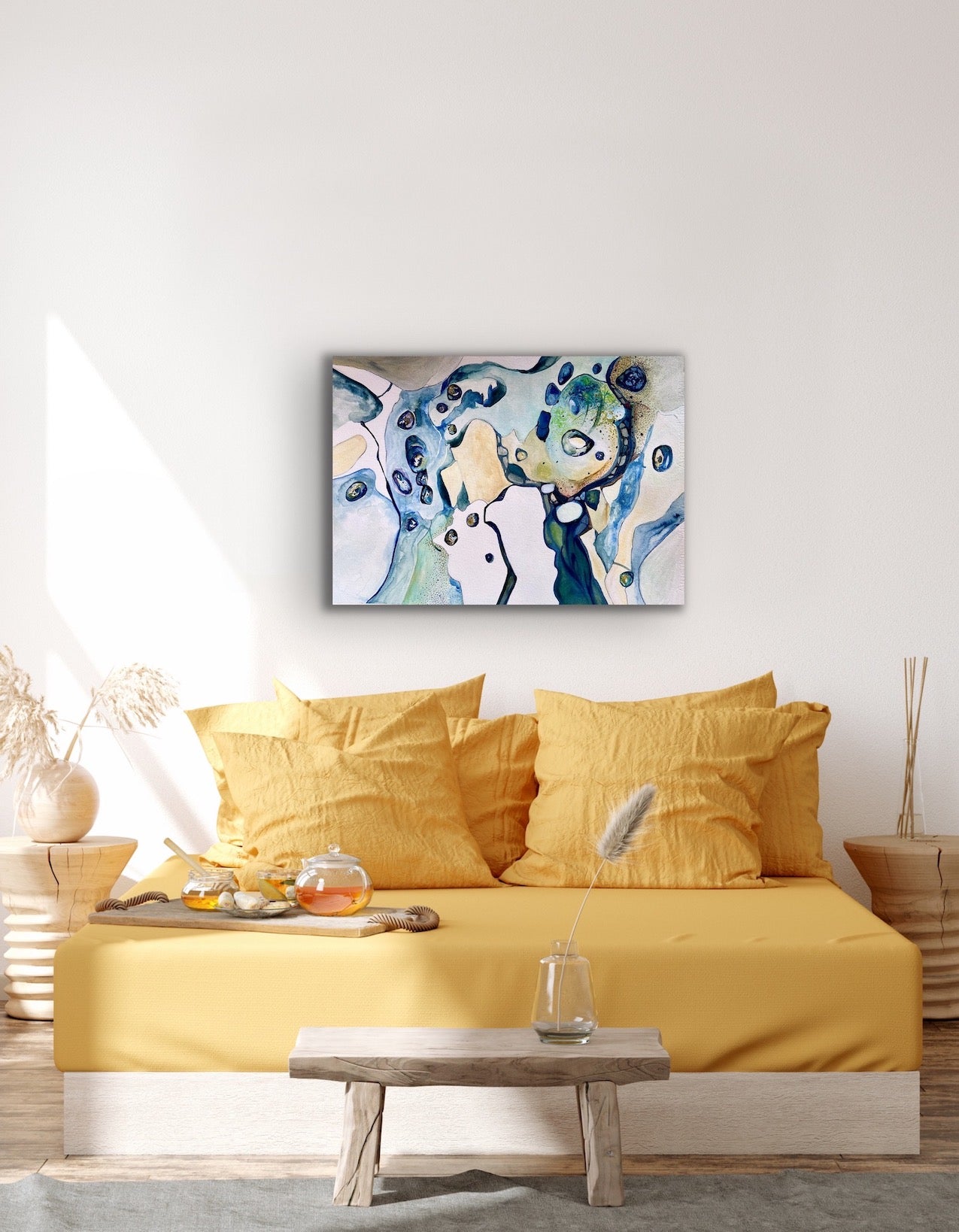 Contemporary abstract painting in shades of blue, turquoise, teal and sand. Shown on living room wall.
