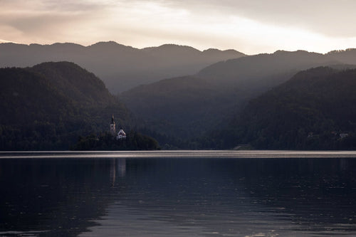 The late afternoon glow lights up the iconic 
church on the small island in Lake Bled, Slovenia.