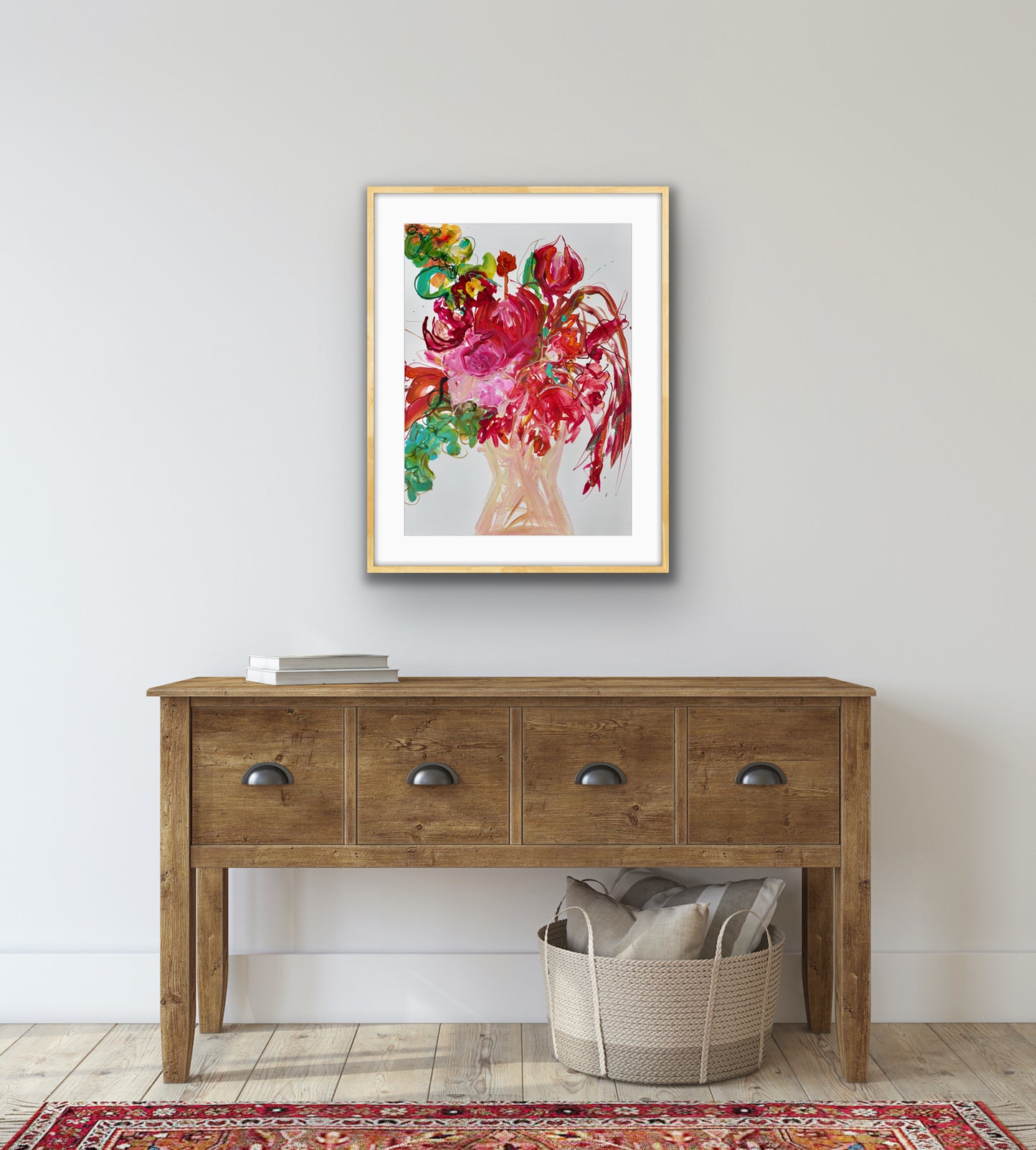 Nude coloured vase of pink and red flowers with green leaves