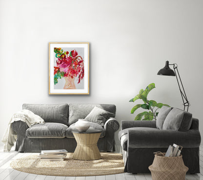 Nude coloured vase of pink and red flowers with green leaves