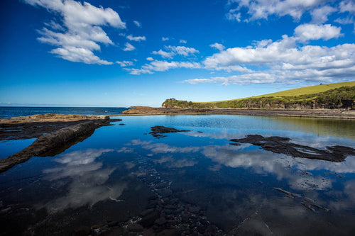 An impossibly blue sky reflects in the ocean pool at Boat Harbour. Gerringong, Australia