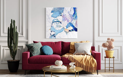 Abstract rock pool painting in shades of blue, white aqua turquoise and mauve.  Shown in situ on a white wall above a red sofa.