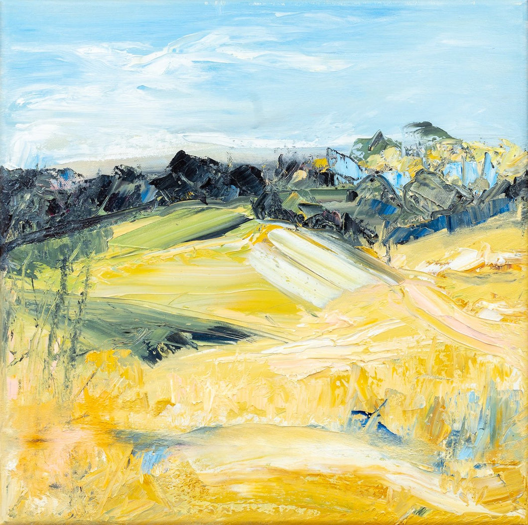 Yellow abstract country landscape with an aqua blue sky and charcoal rocks.