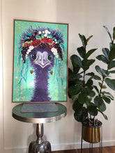 Load image into Gallery viewer, Fun painting of the head and neck of a female emu with a floral headdress against a light green background. Shown on a small round metal table.
