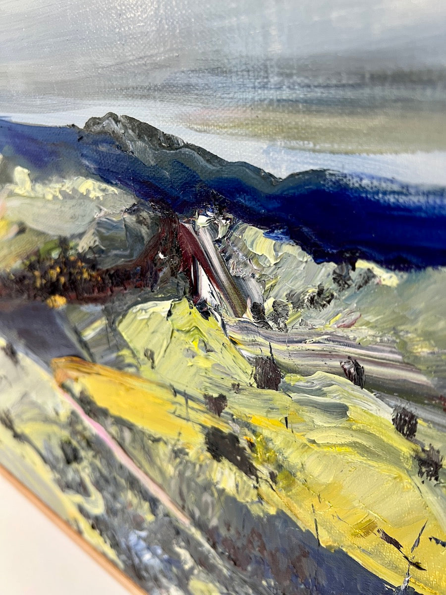 Abstract oil painting of a country landscape with steep hills and lots of colour, yellow, pink, green and blue against a pale blue sky with white clouds. Detail view.