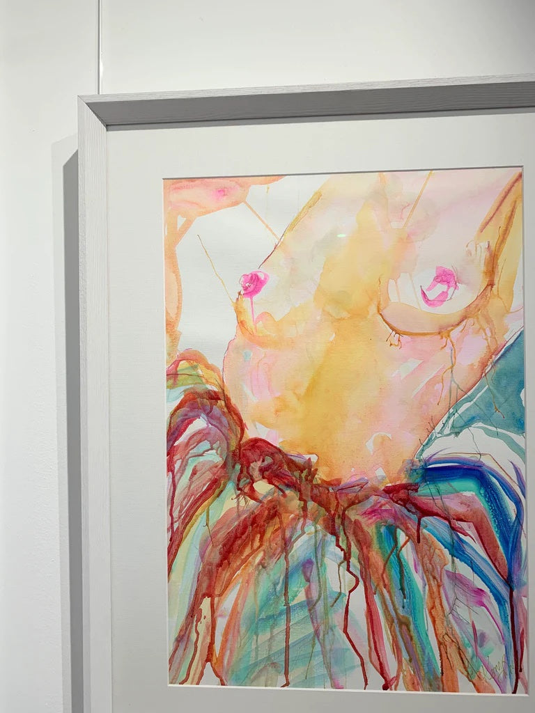 Woman nude from the waist up and wearing a multi coloured skirt. Framed view.