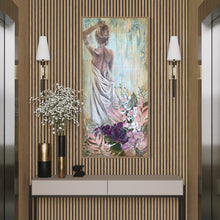 Load image into Gallery viewer, Back view of a woman holding a sheet and her arm up to her hair with tropical flowers in the foreground. In situ view on a timber panelled wall.
