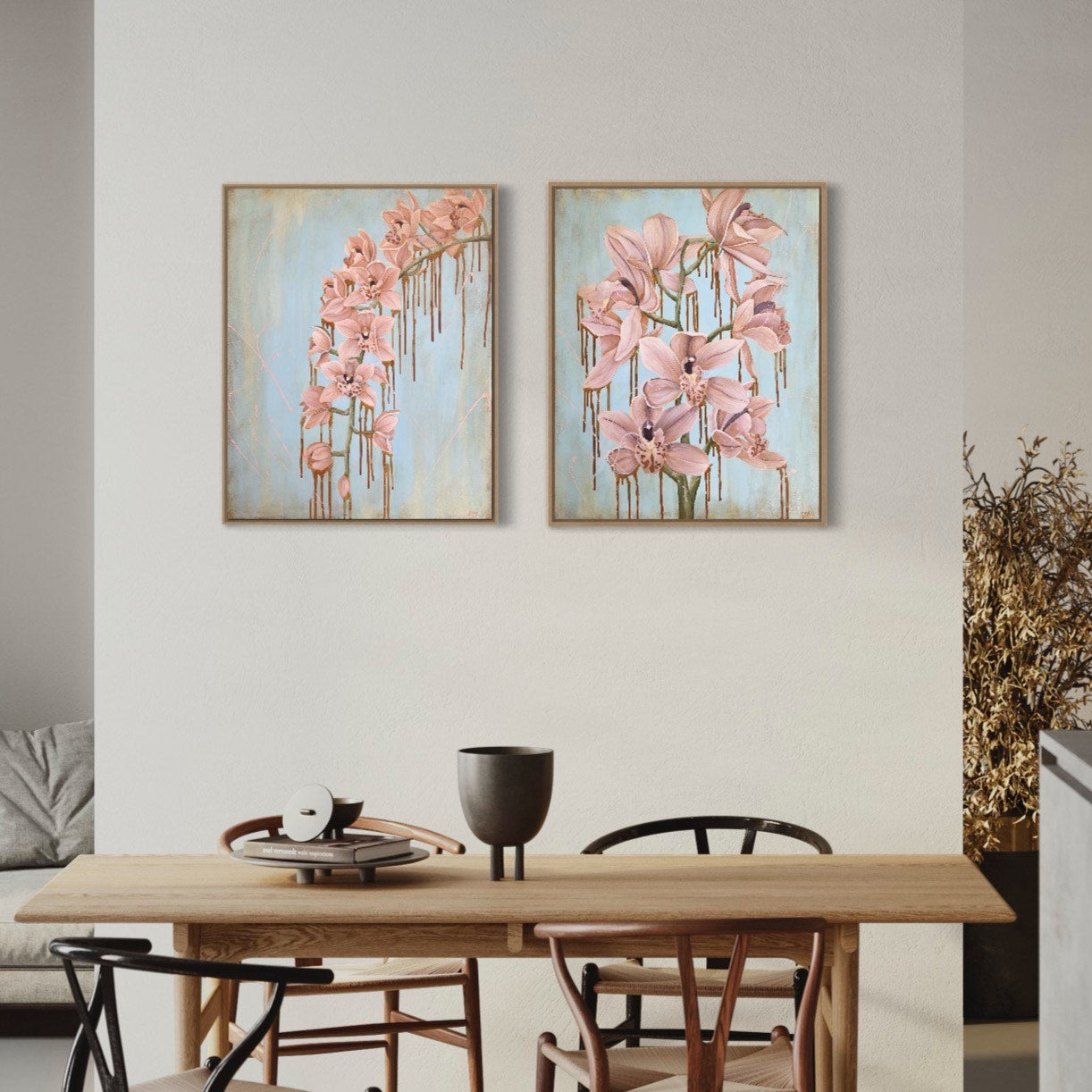 Tropical flowers in a pale shade of pink against a pastel blue background. In situ on a white dining room wall with a matching painting 'Daydreaming'