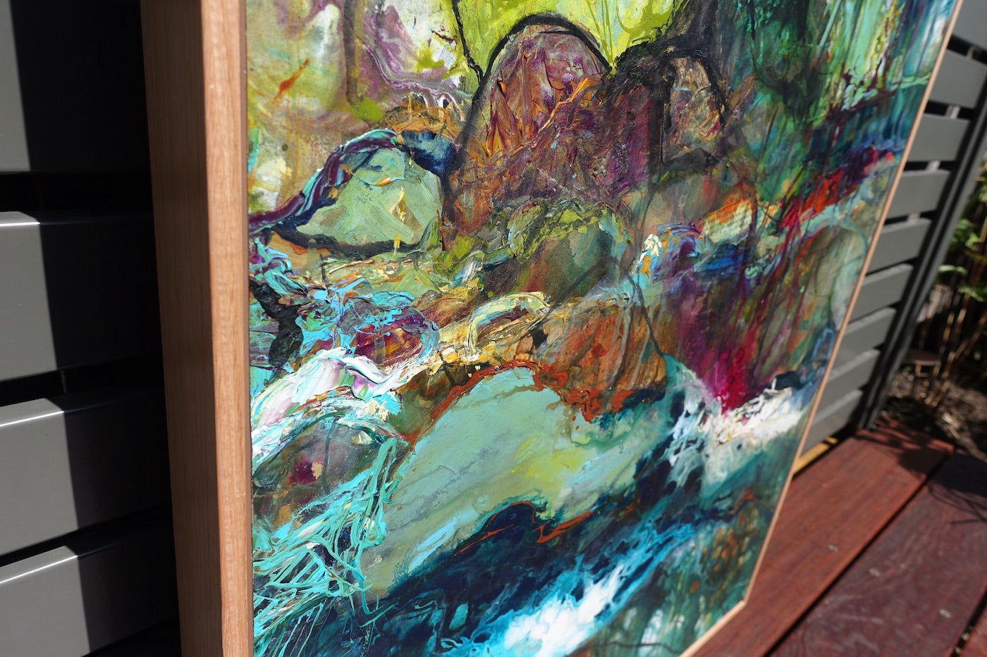 Abstract multicoloured oil painting of a creek, surrounded by trees. Detail 2