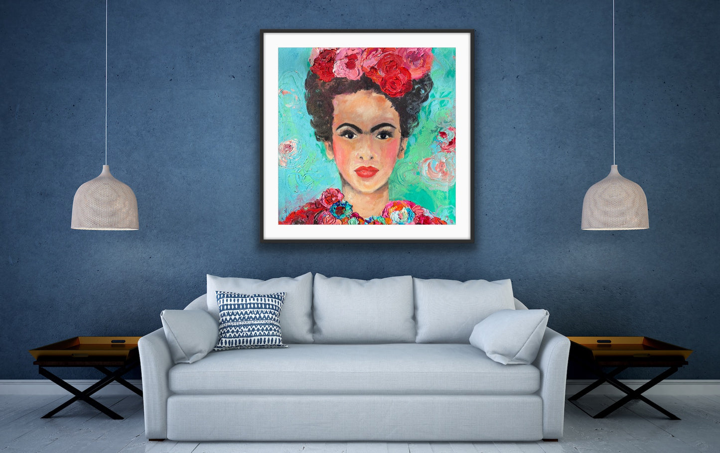 A beautiful and colourful limited edition print of Frida Kahlo with red and pink flowers in Frida's hair against a turquoise and aqua background, in a black frame on a blue wall.