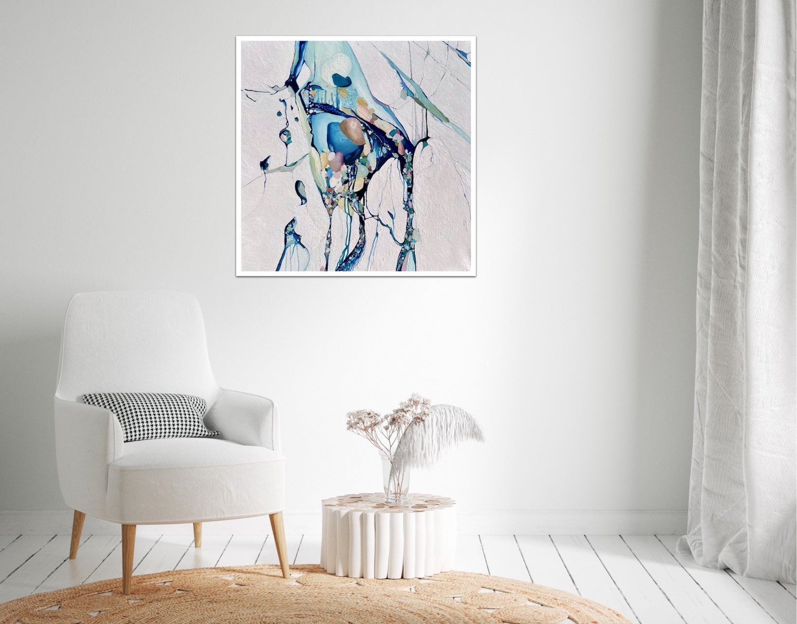 Abstract painting with a background of mostly white with blues and multi coloured detail. Shown on a white wall.