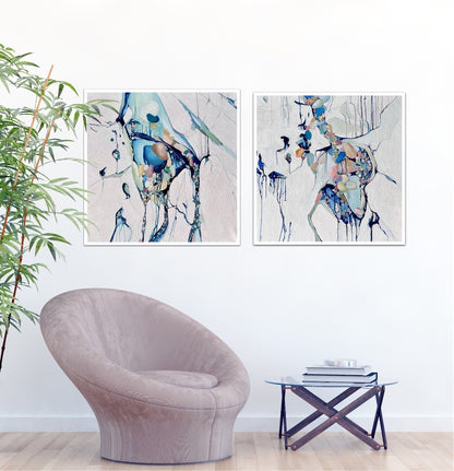 Abstract painting with a background of mostly white with blues and multi coloured detail. Shown on a white wall next to a matching artwork.