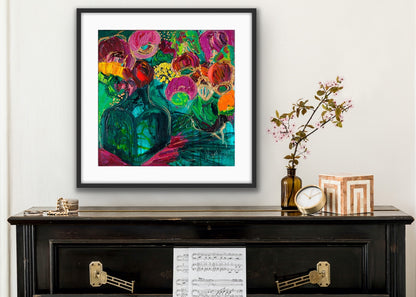 A magnificent bunch of vibrant blooms in a turquoise glass vase against a turquoise, green and magenta background, in a black frame.