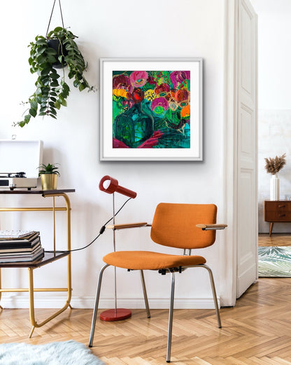 A magnificent bunch of vibrant blooms in a turquoise glass vase against a turquoise, green and magenta background, in a white frame.