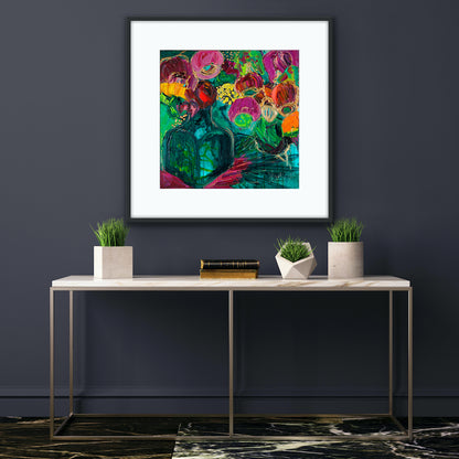A magnificent bunch of vibrant blooms in a turquoise glass vase against a turquoise, green and magenta background, framed in black on a blue wall.