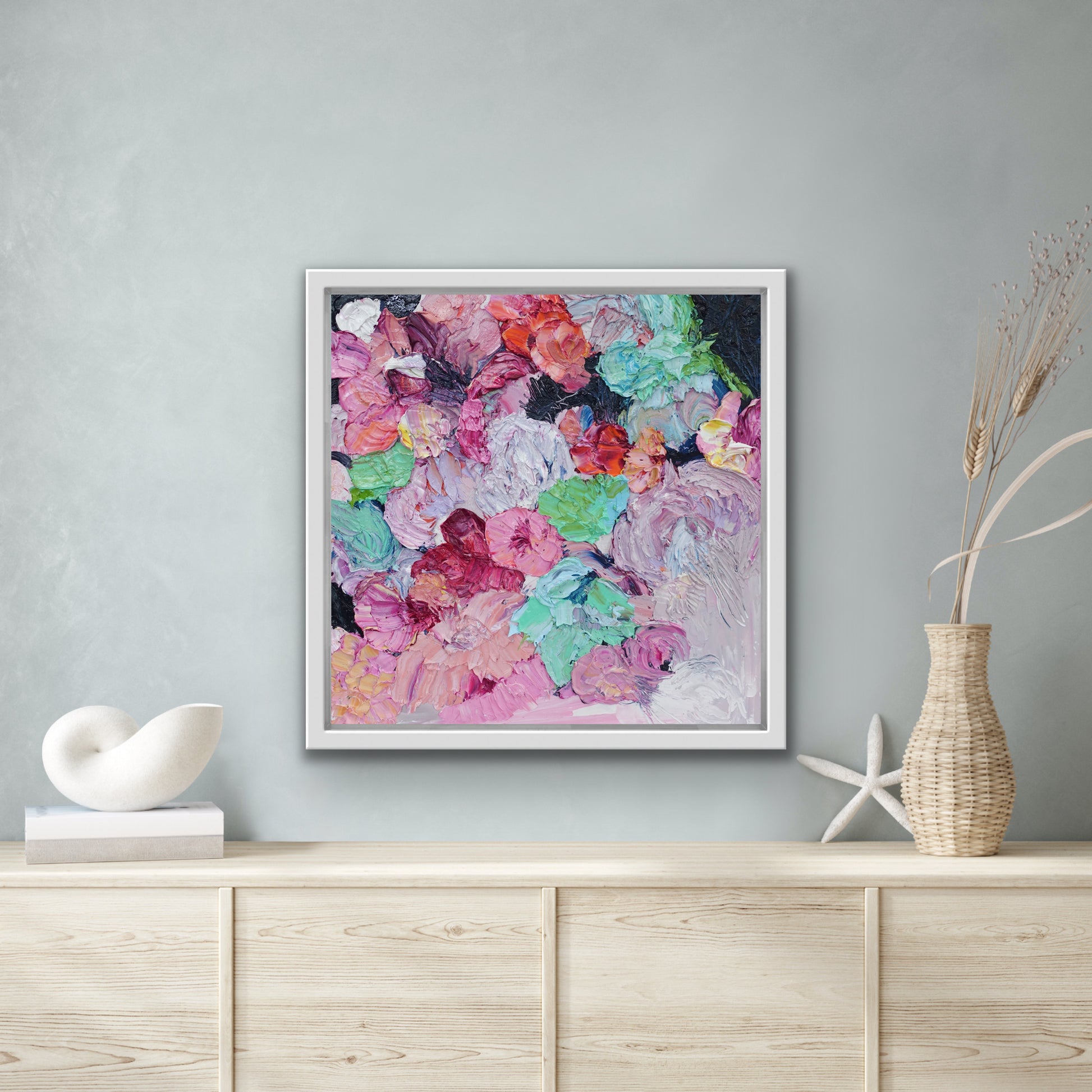 Original painting of blooms in lollipop pastel shades shown on a pale grey wall.