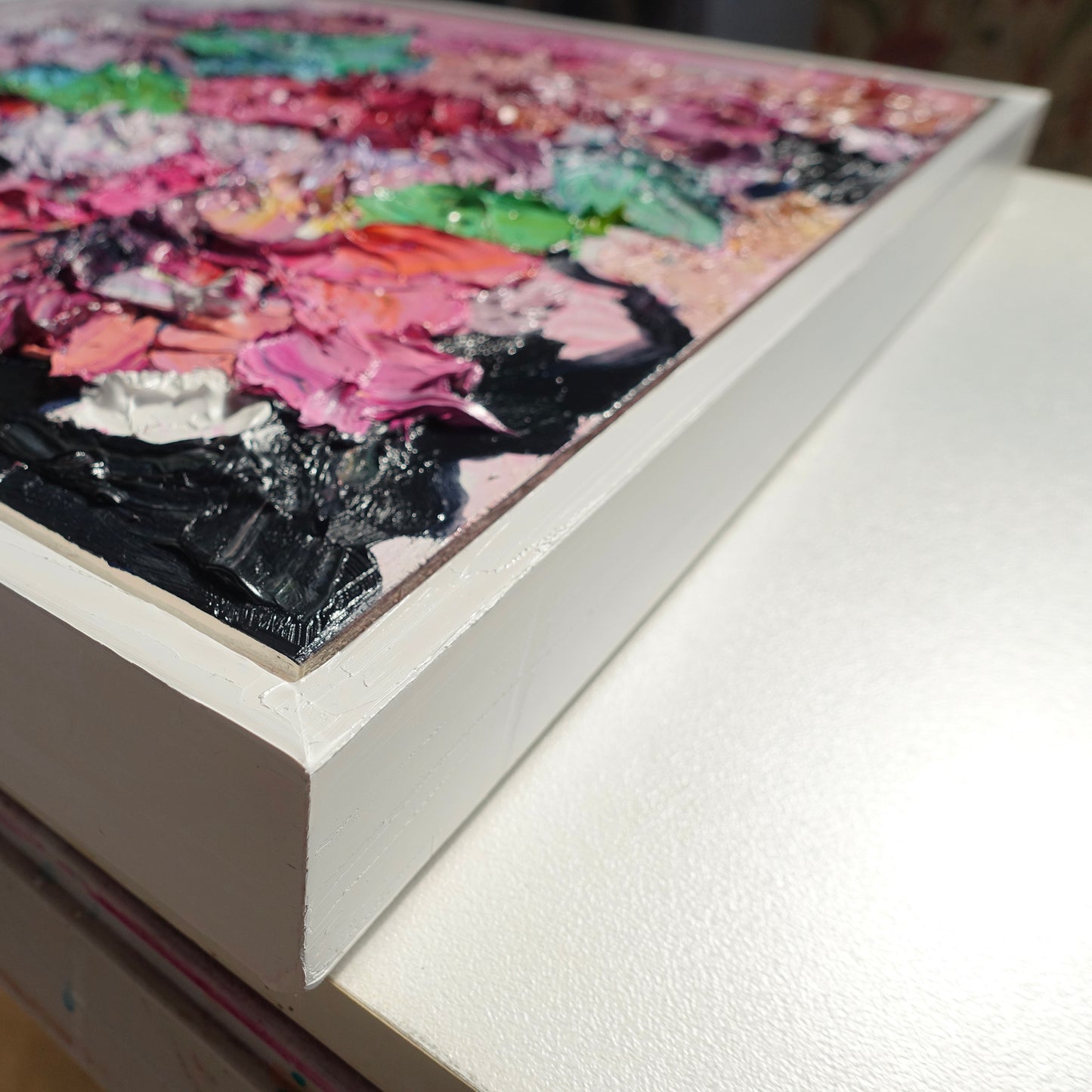 Cloase up view of an original painting of blooms in lollipop pastel shades.