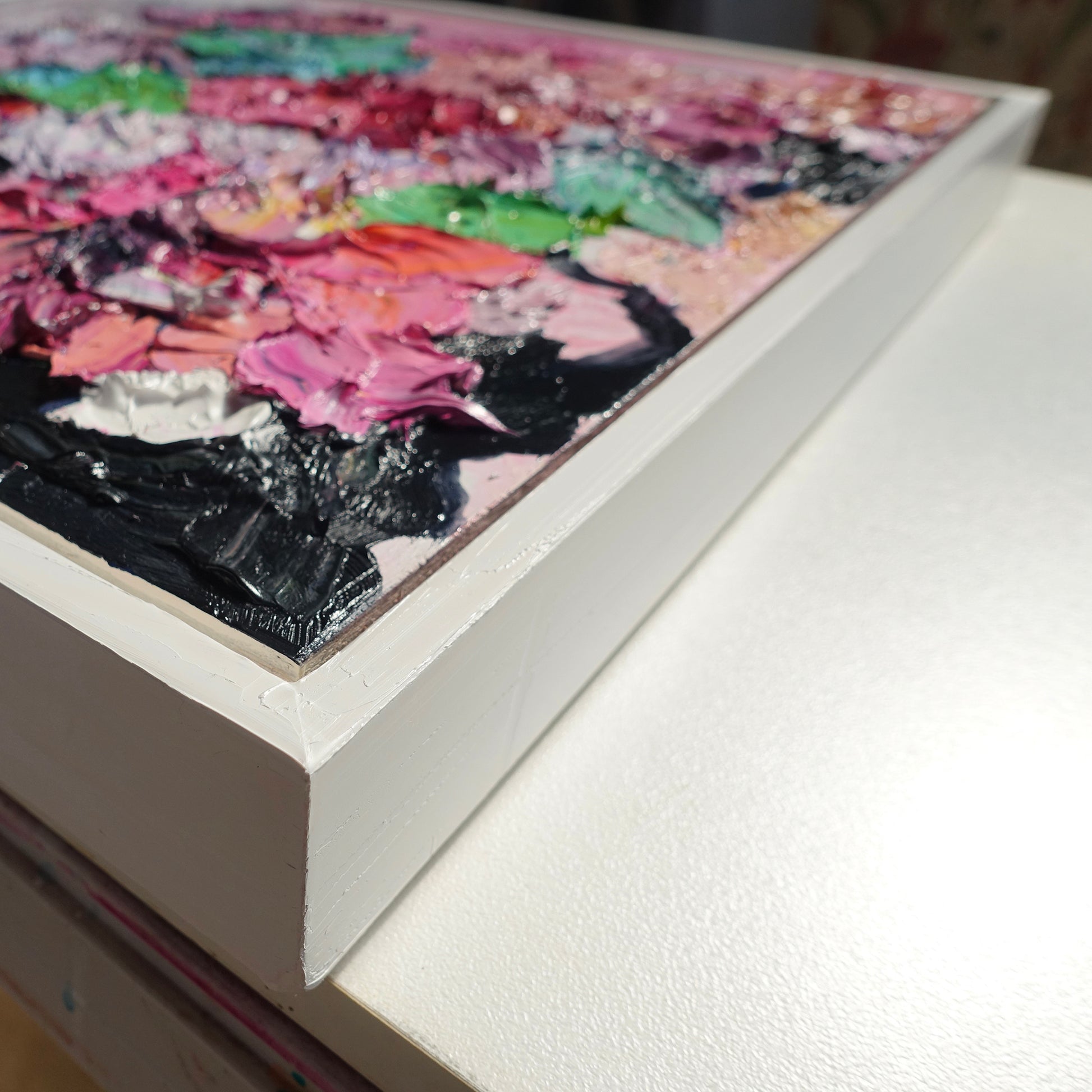Cloase up view of an original painting of blooms in lollipop pastel shades.
