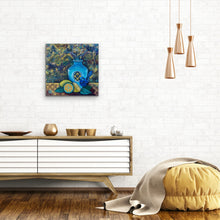 Load image into Gallery viewer, Still life in acrylic and oil. Blue and gold with a blue vase, blue bird and cut lemons and limes on a table. Shown on a white brick wall.
