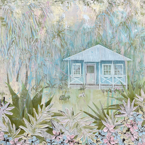 An idyllic pale blue beach cottage with white trim on the windows and verandah. The house is surrounded by palm trees, with a white puppy on the grass in front of the cottage and a garden with fern fronds and flowers. 