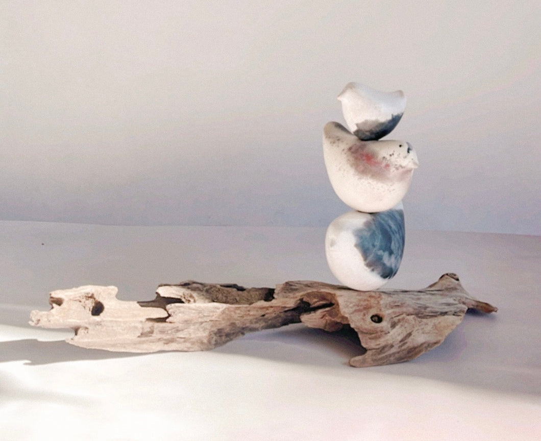 Bird totem sculpture of 3 ceramic birds sitting on driftwood.