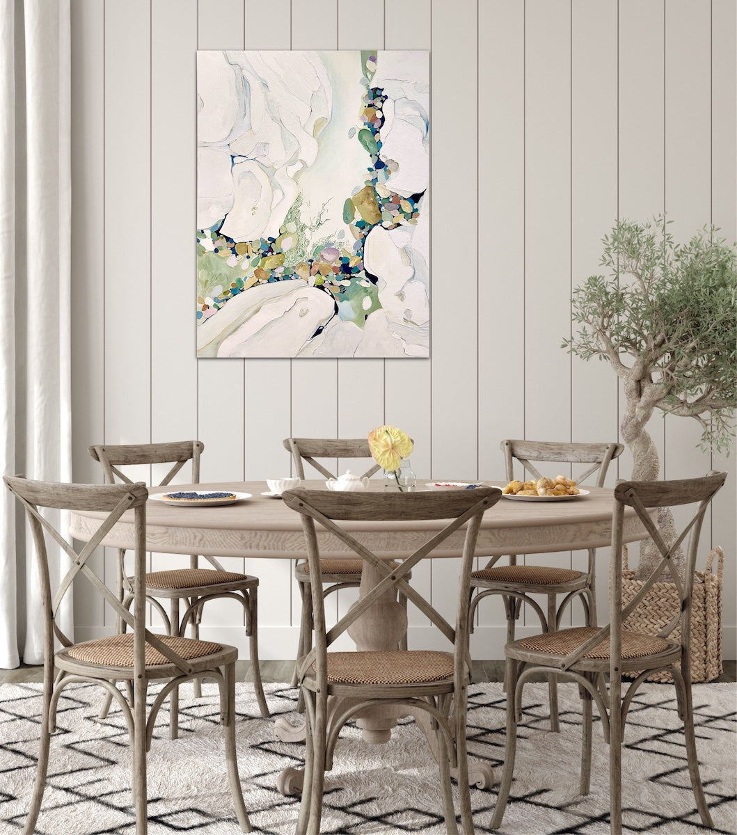 Abstract painting in shades of sea green and oyster white with small multicoloured pieces. In situ on a panelled wall.