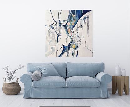 Abstract painting in shades of blue, white, turquoise, pink and yellow. Shown in situ on a white wall above a blue sofa.