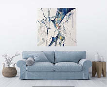 Load image into Gallery viewer, Abstract painting in shades of blue, white, turquoise, pink and yellow. Shown in situ on a white wall above a blue sofa.
