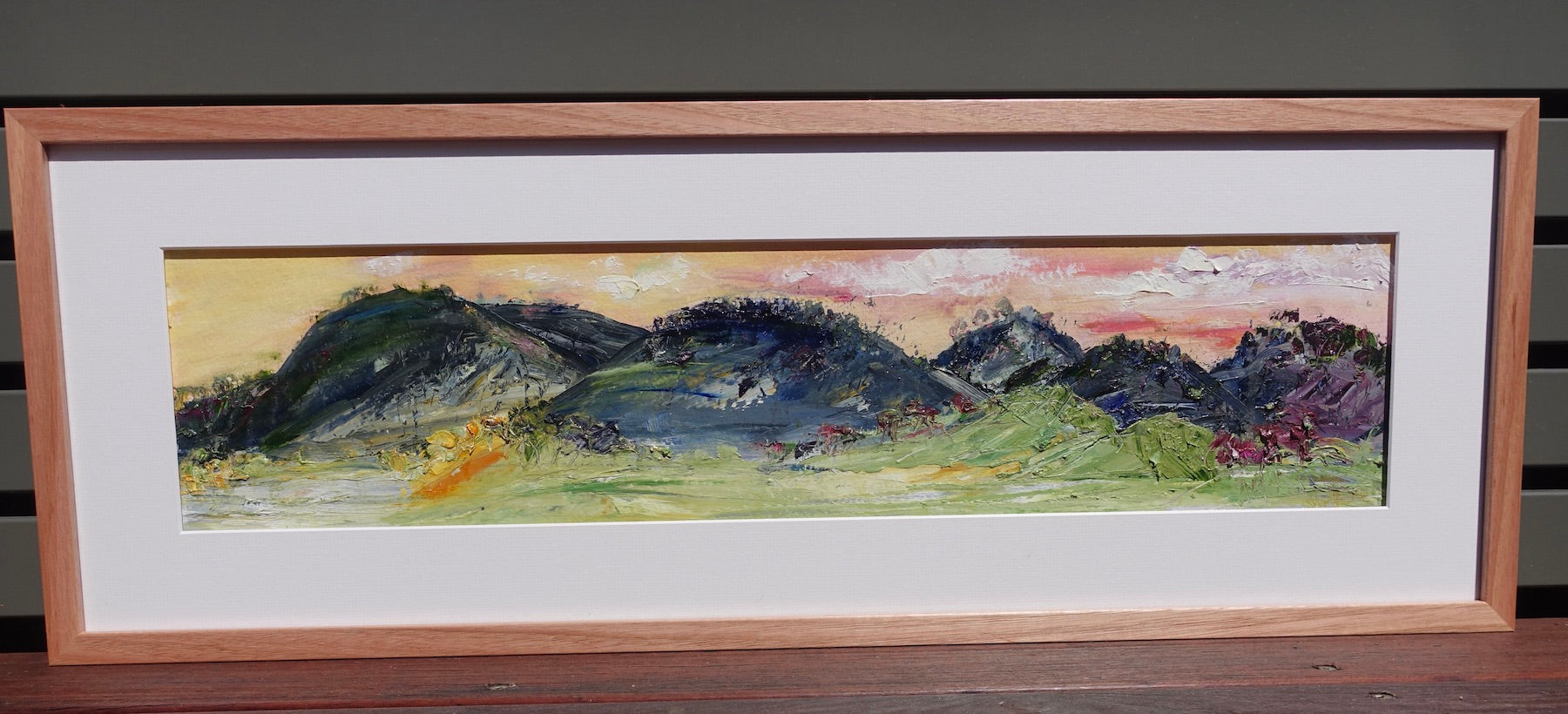 bstract painting of the hills and grassy countryside in Sofala NSW. Framed view.