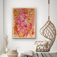 Load image into Gallery viewer, Beautifully coloured expressionist style painting of a vase of blooms in pinks and gold. Shown in situ on a white wall.
