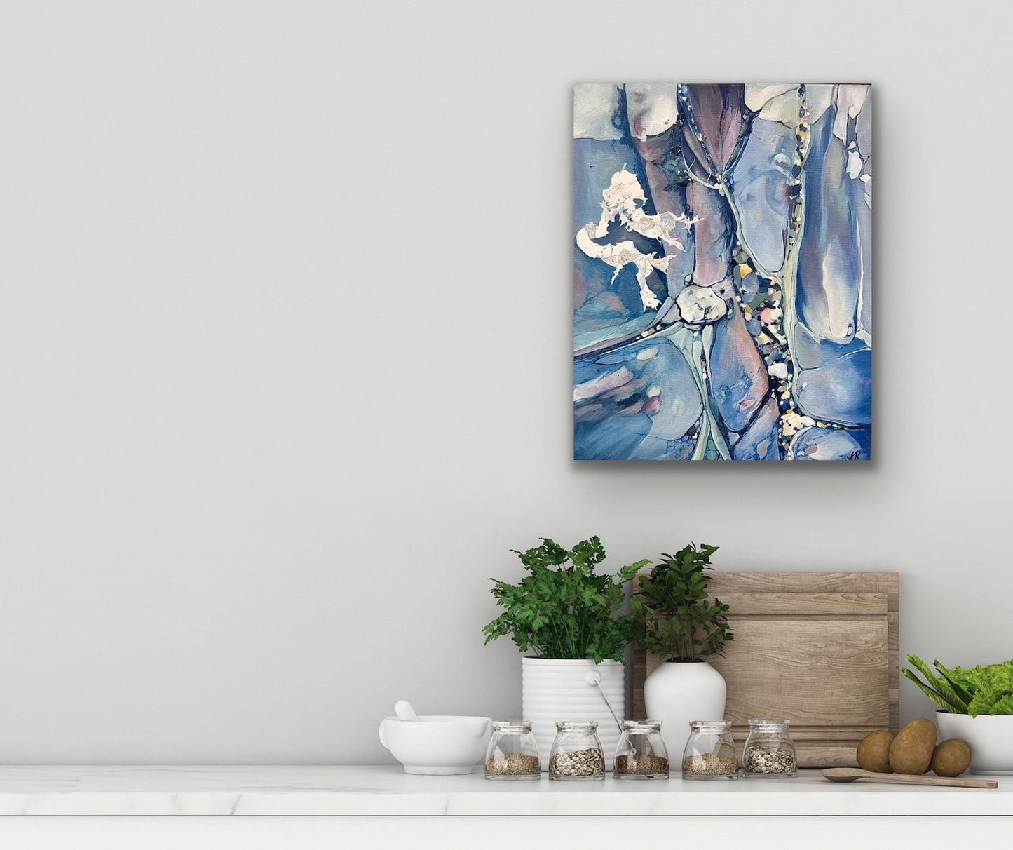 Abstract painting in shades of medium blue. In situ on a pale grey wall.