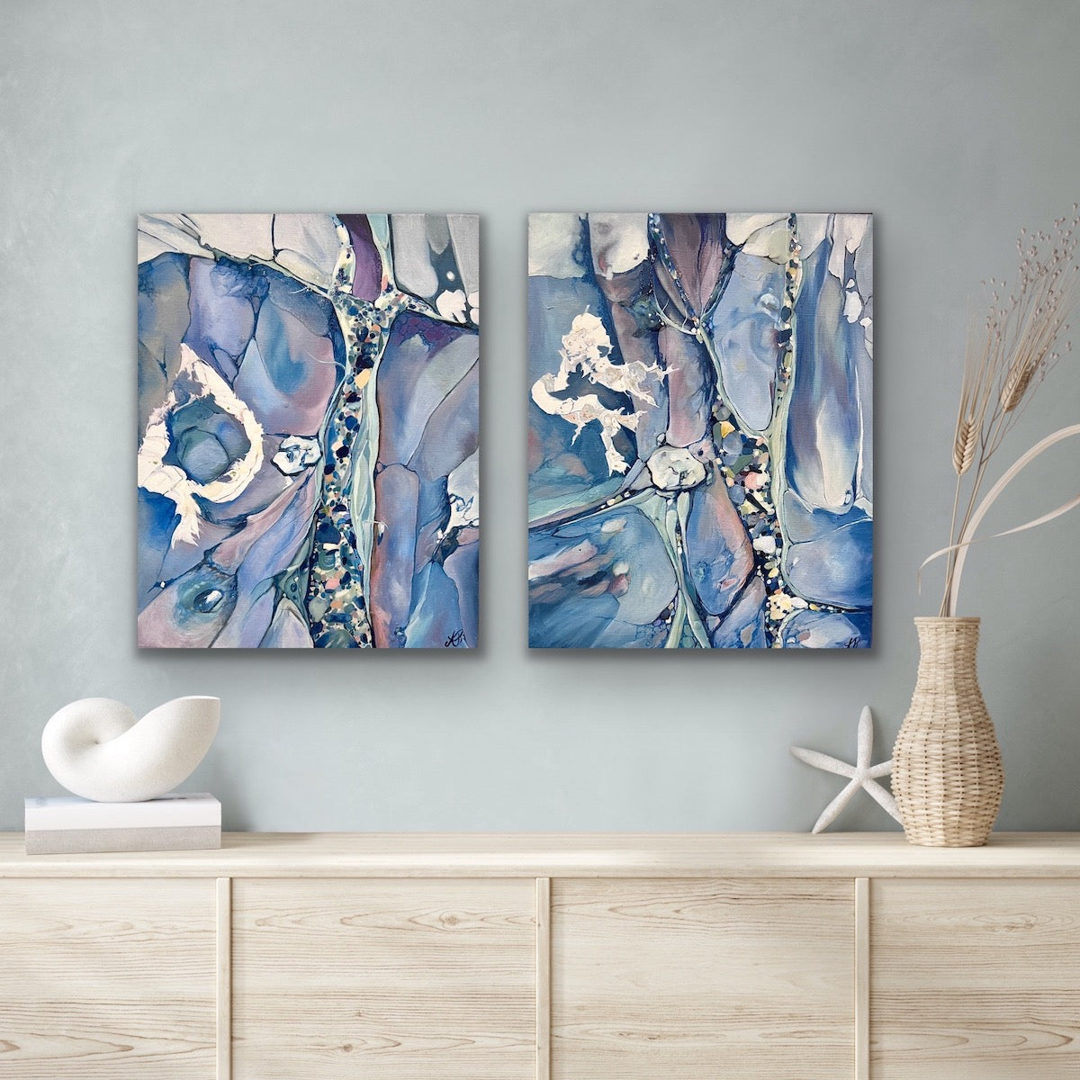 Abstract painting in shades of medium blue. In situ with matching artwork.