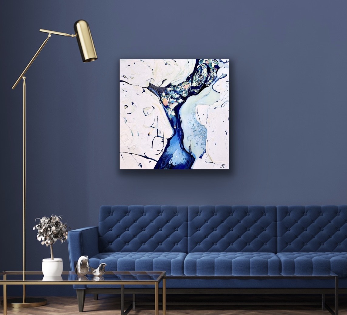 Abstract painting from photographs of ocean rock pools in shades of blue, aqua, rose pink and cream. Shown in situ on a blue grey  living room wall above a mid blue velvet sofa.